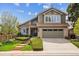 Charming two-story home boasts a well-manicured lawn and a welcoming facade with a two-car garage at 17038 Lamar Dr, Parker, CO 80134