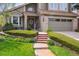 Inviting home entrance with landscaped front yard and a welcoming walkway leading to the front door at 17038 Lamar Dr, Parker, CO 80134