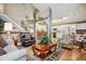 Open-concept living space featuring hardwood floors, natural lighting, and seamless flow to the kitchen at 17038 Lamar Dr, Parker, CO 80134