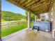 Covered patio with a hot tub and a view of a hillside at 1648 Exquisite St, Castle Rock, CO 80109