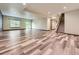 A spacious finished basement featuring luxury vinyl flooring, recessed lighting, and a sliding glass door at 1648 Exquisite St, Castle Rock, CO 80109