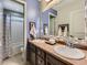 Bright bathroom featuring double sinks, modern fixtures, and a tiled shower/tub combination at 1648 Exquisite St, Castle Rock, CO 80109