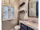 Charming bathroom with decorative windows, elegant fixtures, and vanity with marble countertop at 1648 Exquisite St, Castle Rock, CO 80109