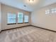 A clean and bright bedroom with carpeted floors, multiple windows, and natural light at 1648 Exquisite St, Castle Rock, CO 80109