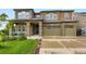 Two-story home featuring a stone and siding exterior, a well-manicured lawn, and a two-car garage at 1648 Exquisite St, Castle Rock, CO 80109