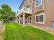 The back of a house with a porch and backyard at 1648 Exquisite St, Castle Rock, CO 80109