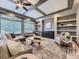 Inviting living room with coffered ceiling, custom built-ins and abundant natural light at 1648 Exquisite St, Castle Rock, CO 80109