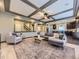 Spacious living room with coffered ceilings and an open floor plan to the kitchen and stairs to the second floor at 1648 Exquisite St, Castle Rock, CO 80109