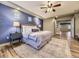 Comfortable main bedroom showcasing a stylish accent wall and tray ceiling at 1648 Exquisite St, Castle Rock, CO 80109