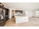 Open-concept kitchen with stainless steel appliances, a large island, and modern finishes at 615 Twilight St, Erie, CO 80516