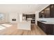 Modern kitchen featuring stainless steel appliances, a large island, and ample cabinet space at 615 Twilight St, Erie, CO 80516