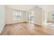 Bright living room with hardwood floors and sliding glass doors to the outdoor deck at 615 Twilight St, Erie, CO 80516