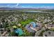 Scenic aerial view of a neighborhood featuring townhomes, a playground, and recreational facilities near a lake at 1379 Charles # 4, Longmont, CO 80503
