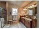 Bathroom with double vanity, tile floor, and glass enclosed shower with shower seat at 1379 Charles # 4, Longmont, CO 80503