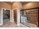 Tiled bathroom with glass enclosed shower and access to the main bedroom and toilet at 1379 Charles # 4, Longmont, CO 80503