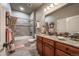 Bathroom with cherry wood vanity, granite countertop, tile floor, and tub-shower combo at 1379 Charles # 4, Longmont, CO 80503