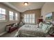 Bedroom featuring three windows, shutters, and a decorative bed frame at 1379 Charles # 4, Longmont, CO 80503