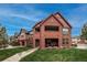 View of the condos from across a grassy lawn, highlighting architectural details at 1379 Charles # 4, Longmont, CO 80503