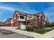 Beautiful townhome with brick exterior, private balconies, attached garage, and landscaped yard at 1379 Charles # 4, Longmont, CO 80503