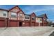 Exterior view of townhomes with attached garages and brick facades that give great curb appeal at 1379 Charles # 4, Longmont, CO 80503