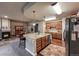 Spacious open kitchen with a large island, wood cabinets, granite counters, and stainless steel appliances at 1379 Charles # 4, Longmont, CO 80503
