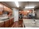 Warm and inviting kitchen features wood cabinets, stainless steel appliances, granite counters, and hardwood floors at 1379 Charles # 4, Longmont, CO 80503