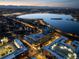Stunning twilight aerial view of the luxury apartment building with a lake and city lights at 4200 W 17Th Ave # 323, Denver, CO 80204