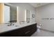 Modern bathroom showcasing dual sinks, sleek vanity, and illuminated mirrors for a spa-like ambiance at 4200 W 17Th Ave # 323, Denver, CO 80204