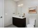 Updated bathroom with a modern vanity, marble countertop, a bright mirror, and ample lighting at 4200 W 17Th Ave # 323, Denver, CO 80204