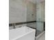 Contemporary bathroom boasting a soaking tub, separate glass enclosed shower, and stylish tile at 4200 W 17Th Ave # 323, Denver, CO 80204