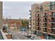 Modern brick apartment building with balconies overlooks park, lake and city views at 4200 W 17Th Ave # 323, Denver, CO 80204