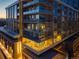 Modern high-rise condo building with multiple balconies and expansive windows at dusk at 4200 W 17Th Ave # 323, Denver, CO 80204
