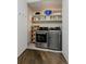 Laundry room featuring modern washer and dryer with ample storage space and wood plank flooring at 4200 W 17Th Ave # 323, Denver, CO 80204