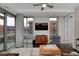 Stylish living room with a ceiling fan, a view of the balcony, and a sleek entertainment center at 4200 W 17Th Ave # 323, Denver, CO 80204