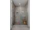 Tiled shower with glass door and wooden bench seating at 4200 W 17Th Ave # 323, Denver, CO 80204