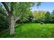 Spacious backyard with stone-lined garden and firepit, ideal for relaxing and enjoying the outdoors at 19113 W 60Th Ln, Golden, CO 80403