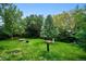 Green backyard featuring mature trees and an eclectic bird-feeding station with room for the local birds at 19113 W 60Th Ln, Golden, CO 80403
