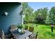 Backyard patio features outdoor seating, lush greenery, and a fire pit with a view of the trees at 19113 W 60Th Ln, Golden, CO 80403