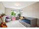 Well-lit room featuring a trundle bed, natural light, and a small workstation with a plush chair at 19113 W 60Th Ln, Golden, CO 80403