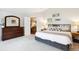 Well-lit bedroom with a decorative dresser and access to a nearby living space at 19113 W 60Th Ln, Golden, CO 80403