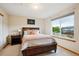 Cozy bedroom featuring a large window and a decorative bedframe with under-bed storage at 19113 W 60Th Ln, Golden, CO 80403