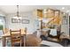 Bright dining area near staircase and entry featuring a hardwood table and chairs at 19113 W 60Th Ln, Golden, CO 80403