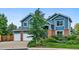 Charming two-story home with blue siding, brick accents, and a well-manicured lawn, offering great curb appeal at 19113 W 60Th Ln, Golden, CO 80403