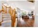 Grand foyer with hardwood floors, a staircase, and a view of the living room with a fireplace at 19113 W 60Th Ln, Golden, CO 80403
