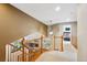Bright hallway with wood banisters, providing access to the upper-level rooms at 19113 W 60Th Ln, Golden, CO 80403