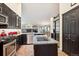 Modern kitchen with stainless steel appliances, dark cabinets, and a central island with sink at 19113 W 60Th Ln, Golden, CO 80403