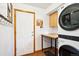 Efficient laundry room equipped with modern washer and dryer, plus storage and workspace at 19113 W 60Th Ln, Golden, CO 80403