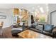 Comfortable living room featuring leather sofas, a wooden coffee table, and an open floor plan at 19113 W 60Th Ln, Golden, CO 80403