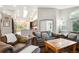 Inviting living room with comfortable leather couches, a wooden coffee table, and bright natural light at 19113 W 60Th Ln, Golden, CO 80403