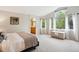 Spacious main bedroom with large windows, neutral colors, and an attached bathroom at 19113 W 60Th Ln, Golden, CO 80403
